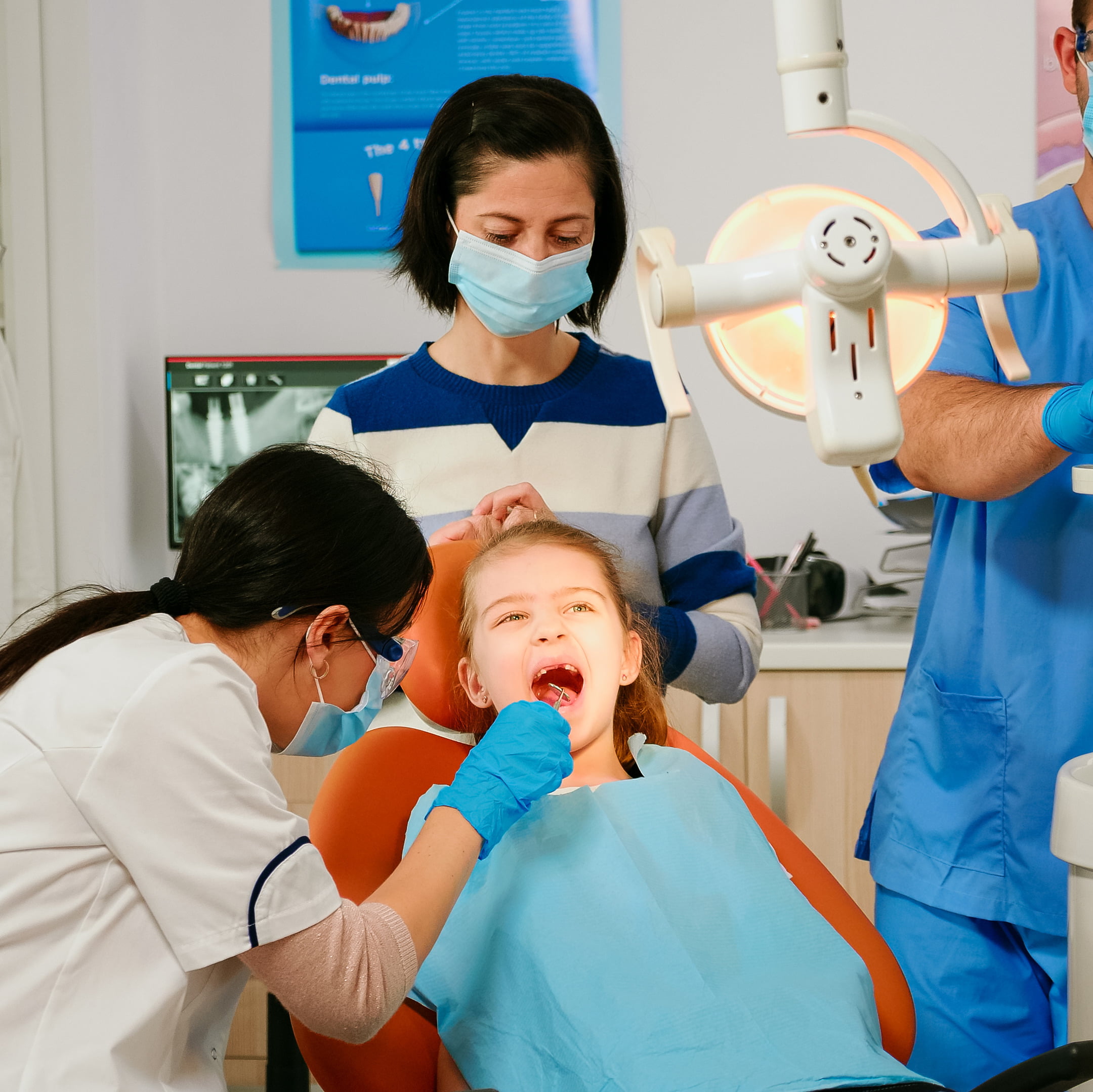 woman orthodontist lighting lamp examining little patient using sterile dental tools stomatological clinic dentistry doctor speaking kid sitting stomatological chair girl opening mouth 1